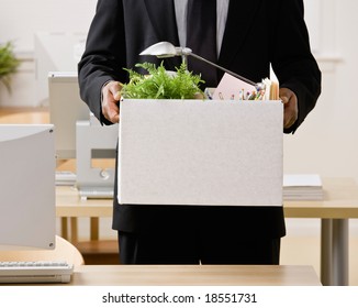 Fired Businessman Packing Personal Desk Items In Box