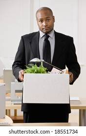 Fired Businessman Sadly Packing Personal Desk Items In Box