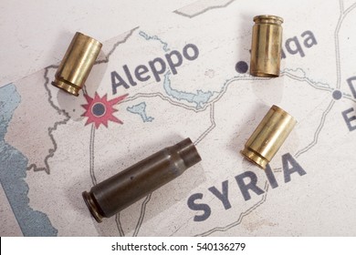 The fired cases with 9mm bullets and Kalashnikov. Background view on map of Aleppo, Syria. Stop war in Syria. 