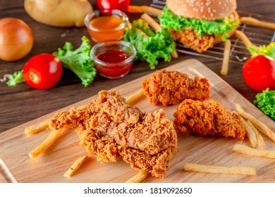 Fired chicken and chicken nuggets and spicy drumsticks on wooden background. Set of fired crispy chicken. Crispy fried chicken in  decoration with ingredient on  wooden table background