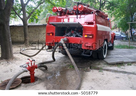 fireengine connected to firecock by firehose