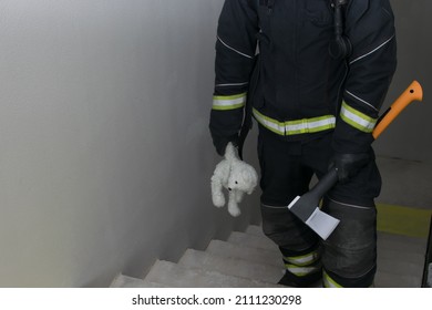 A Firefighter Climbs The Stairs, Holding A Teddy Bear Toy And A Hatchet For Opening Doors, There Is A Place For An Inscription