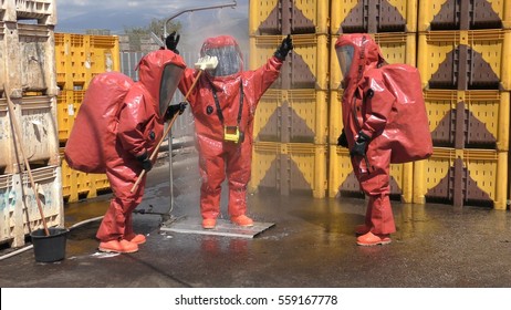 Firefighter Dressing Protective Suit Cleans Up After Sealing A Leaking Container From Corrosive Toxic Hazardous Material Ammonia In Fruit Factory, Yesud Hamaala, Israel, March 21, 2016.