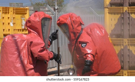 Firefighter Dressing Protective Suit Cleans Up After Sealing A Leaking Container From Corrosive Toxic Hazardous Material Ammonia In Fruit Factory, Yesud Hamaala, Israel, March 21, 2016.