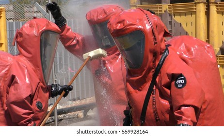 Firefighter Dressing Protective Suit Cleans Up After Sealing A Leaking Container From Corrosive Toxic Hazardous Material Ammonia In Fruit Factory, Yesud Hamaala, Israel, March 21, 2016.