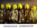 Firefighter - Firefighting gear including helmets, gloves, jacket and trousers among other clothing and equipment in fire station