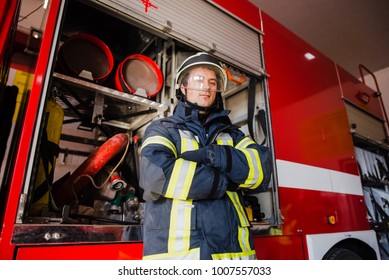 Firefighter, fireman. Emergency safety. Protection, rescue from danger. Fire fighter in protective helmet. Adult man, hero in equipment, uniform at work.