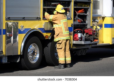 Firefighter Getting Gear From The Fire Truck