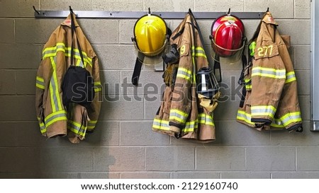 Firefighter helmet and protection coat hanging in the fire station Stock foto © 