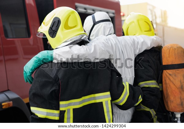 firefighter help and carry victim\
people from disaster out danger area, firefighter\
concept