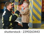 Firefighter holding child boy to save him in fire and smoke,Firemen rescue the boys from fire.