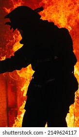 Silhouette￼ Of A Firefighter Inside A Burning Building.