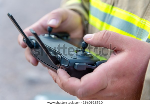firefighter\
operating drone in search and\
rescue.