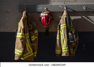 Firefighter protection clothes and helmet hanging in the fire station