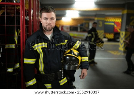 A firefighter puts on a fire uniform at the fire department.