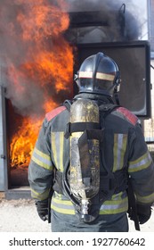Firefighter putting out fire training station extinguisher backdraft emergency safety drill procedure.