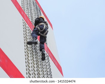 Firefighter Or Rescue Climbing On High Building With Rope And Hook, Equipment For Rescue.