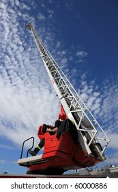 Firefighter Serving With The Fire Truck Ladder Extended.