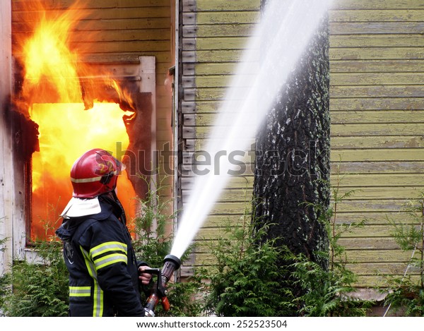 Firefighter Sprays Water Burning House Stock Photo (Edit Now) 252523504