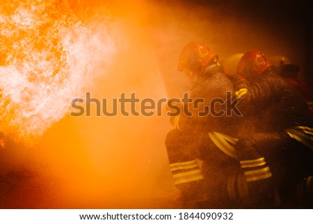 Firefighter training. fireman using water and extinguisher