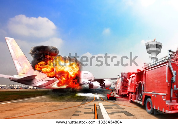 Firefighter truck and fire\
robot unit during battle fire on aircraft crashing with exploding\
engine on fire