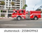 Firefighter truck spees up in the city.