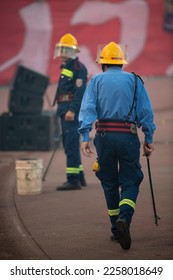 Firefighter with uniform in the Stadium during the soccer event removing torches. Torches and atmosphere during Eternal soccer derby in Belgrade, Serbia 22.05.2022 - Shutterstock ID 2258018649