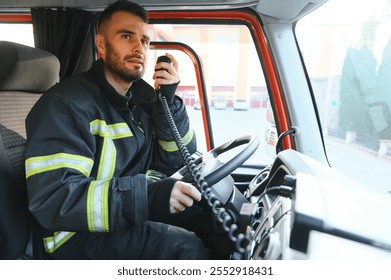 Firefighter using radio set while driving fire truck.