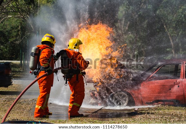Firefighter are using water in fire fighting\
operation. Fire on burning car lpg ngv Gas-powered vehicles / Fire\
and rescue training school regularly to get ready - Help, Fire\
training exercise\
concept
