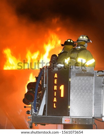 Firefighters battle a large commercial fire
