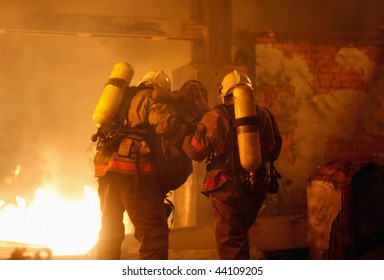 A Firefighters Carrying An Accident Victim From A Fire