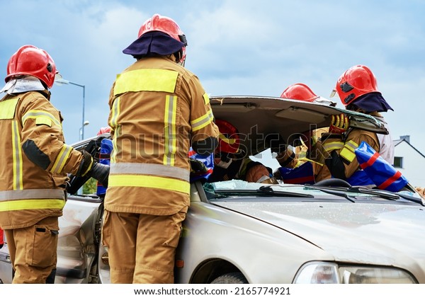 Firefighters during a rescue operation training.\
Rescuers unlock the passenger in car after accident. Katy\
Wroclawskie, Poland - May 28,\
2022