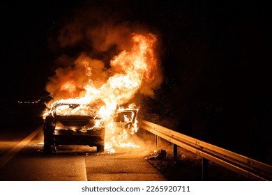 Firefighters extinguish burning car on highway