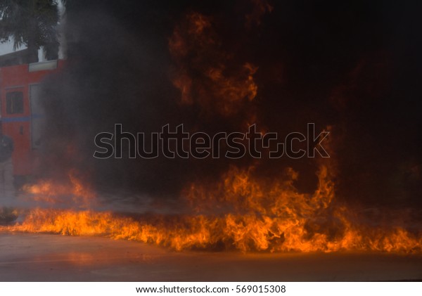 Firefighters extinguish a fire during a\
training exercise.