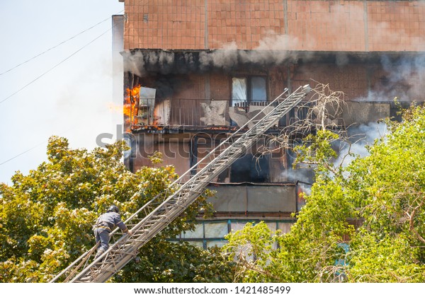 firefighters extinguish a fire in a high-rise\
residential\
building