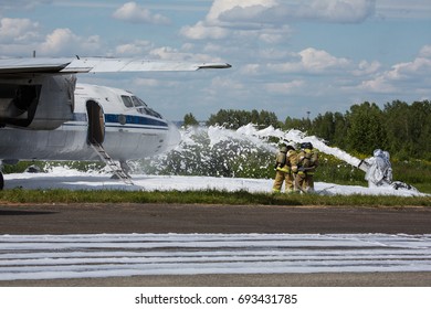 Firefighters Extinguish A Plane. Fill The Plane With Fire-fighting Foam After Emergency Landing