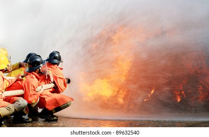 Firefighters fighting fire during training - Powered by Shutterstock