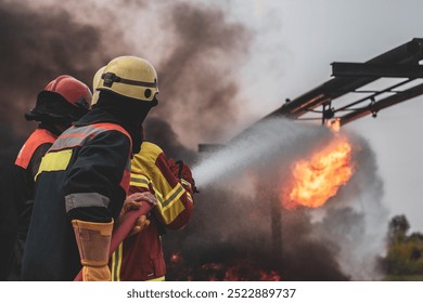 Firefighters fighting the flames of an oil fire - Powered by Shutterstock