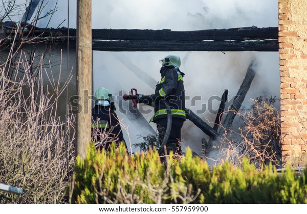 Firefighters Fighting House Fire Stock Photo (Edit Now) 557959900