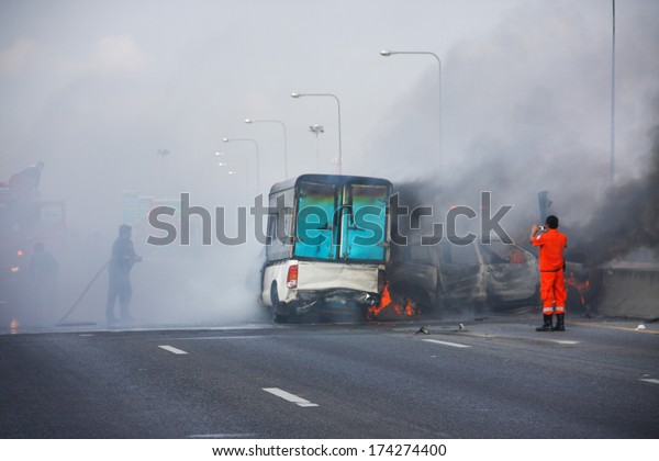 firefighters fire small truck with Truck\
caps car explosive car crash and catch fire on\
motorway