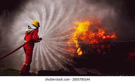 Firefighters, Firemen spraying high pressure water or suitable extinguishing agents to fire with copy space .