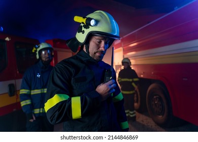 Firefighters Men And Woman At Action With Fire Truck In Background At Night