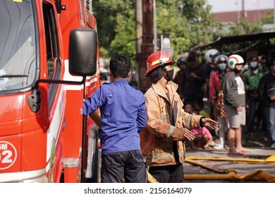 Firefighters on standby and trying to extinguish the fire at the furniture warehouse fire site. : Yogyakarta, Indonesia - 12 May 2022
