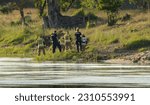 Firefighters and police officers by the river conduct an investigation or activities related to the drowning of a man. Corpse in the river

