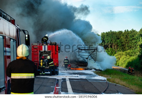 Firefighters put out the fire with foam
in the car, fire engine extinguishes a fire on the
road