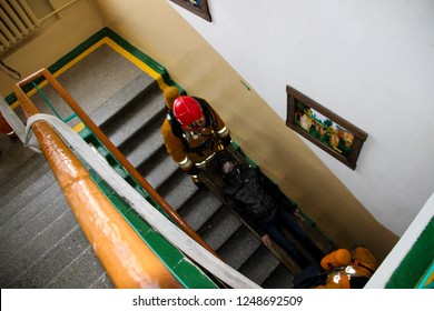 Firefighters Rescue Children From School. Belarus/Oshmyany/25 November 2018. Practicing The Actions Of Rescuers During A Fire. Evacuation Of Children