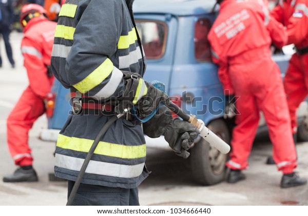 Firefighters in a rescue operation after road traffic\
accident 