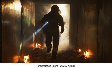 Firefighters Running Through Hallway Of Burning Building