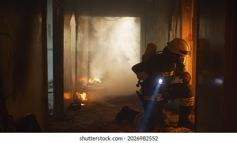 Firefighters Running Through Hallway Of Burning Building