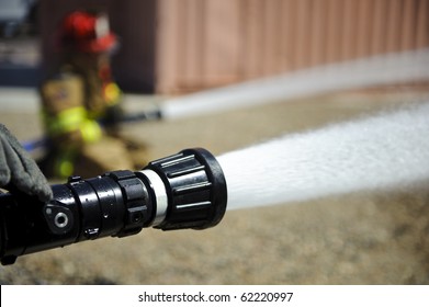 Firefighters spray water during a training exercise.